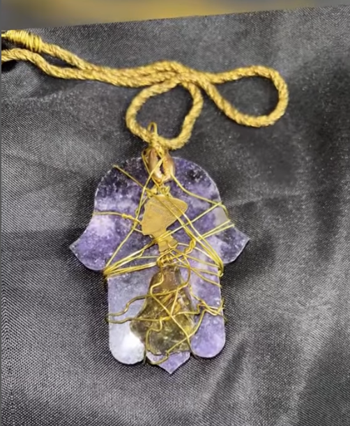 Amethyst pendant from Ra Sekhi Arts Temple designed for protection, intuition, emotional balance, and spiritual healing, crafted as part of their sacred jewelry collection rooted in African ancestral wisdom.