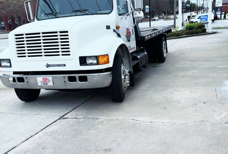 White tow truck operated by Relentless Roadside Assistance, showcasing professional towing and roadside support services designed for quick response and driver safety.