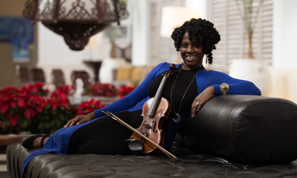 Kimberly Coleman Kim Strings Posing with Violin on Sofa – Kim Strings Music Atlanta GA